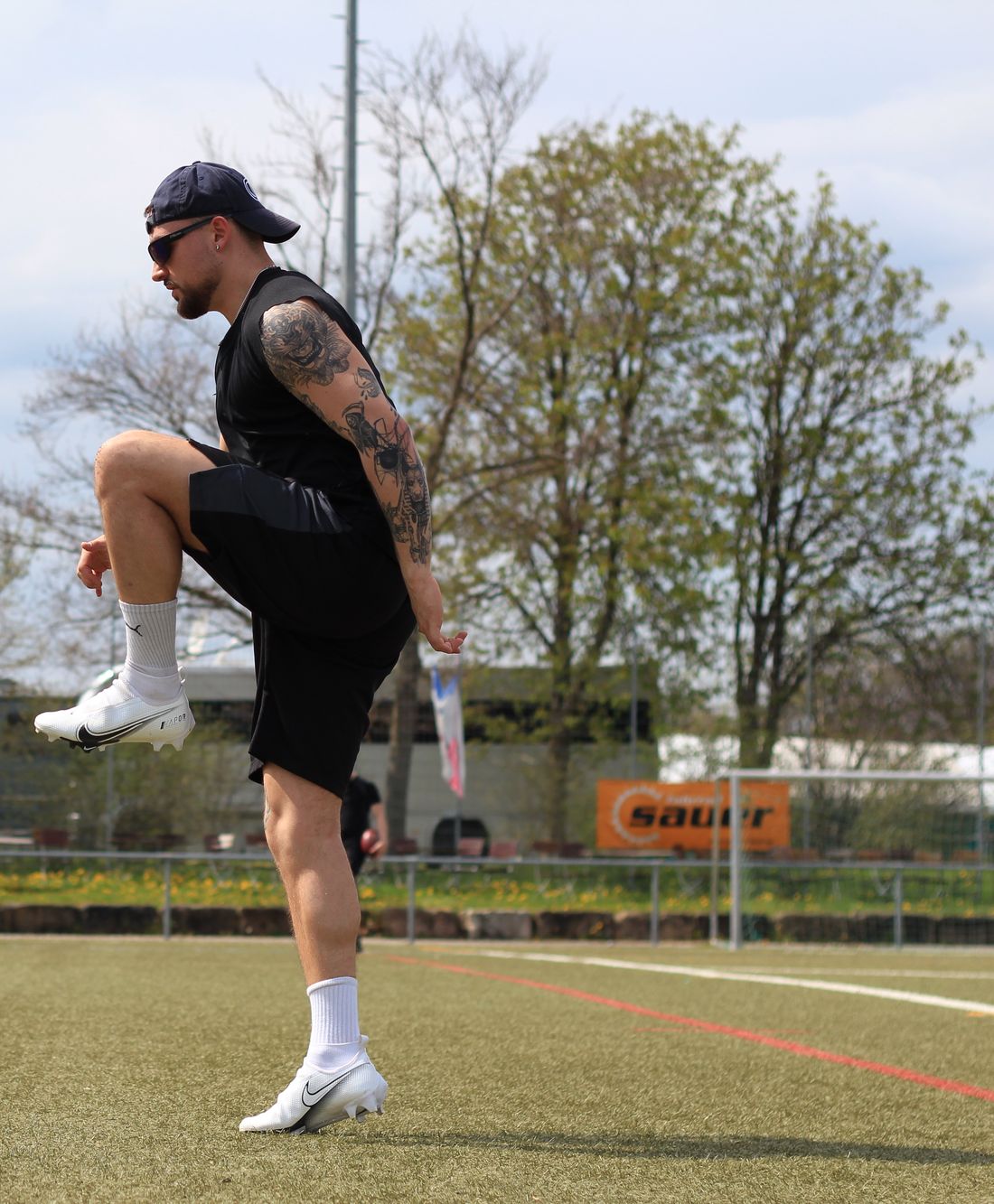 Nate Bock doing a high-knee drill on a pitch.